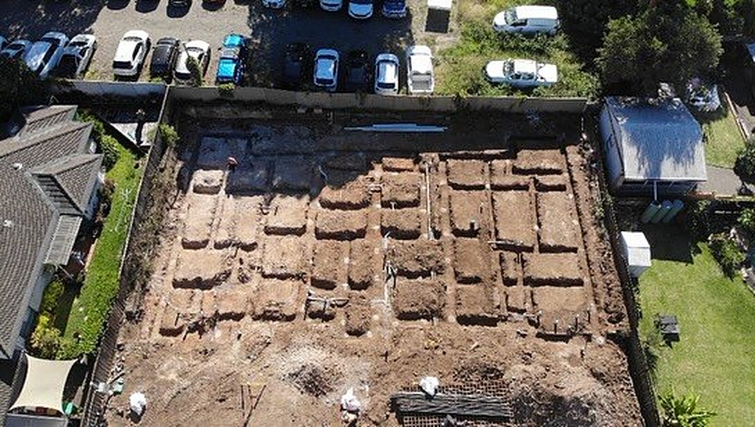 Trenched site prepared beside neighbouring homes