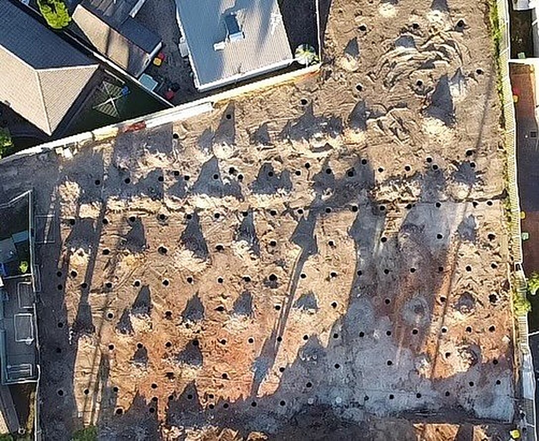 Pier holes in neat rows across a block